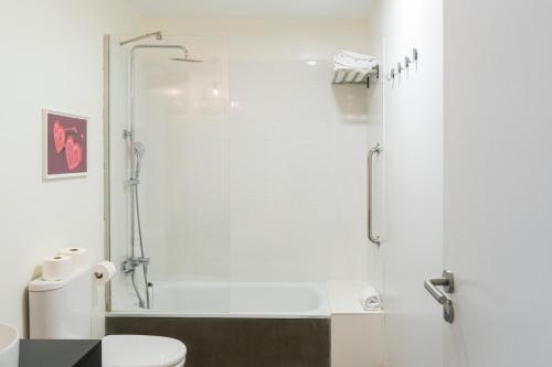 a bathroom with a shower and a toilet at Buendía Corralejo Nohotel in Corralejo