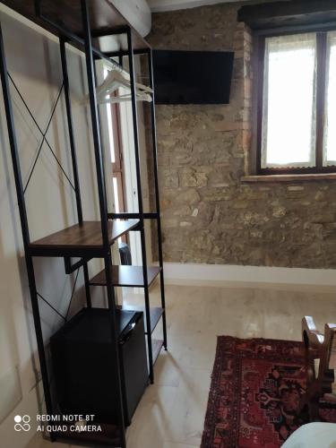 a room with a black book shelf and a window at ElsAnto-beb in San Venanzo