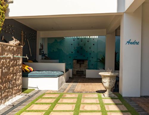 a bedroom with a bed on a patio at Withuis Hartenbos - No Load Shedding in Hartenbos