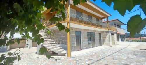 a building with stairs on the side of it at Barcelos Habadia House in Lijó