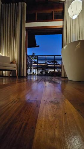 a living room with a wooden floor and a couch at Tiradentes Boutique Hotel in Tiradentes