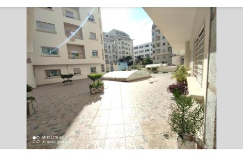 a courtyard of a building with a bed in the middle at Resedence val iris in Tangier