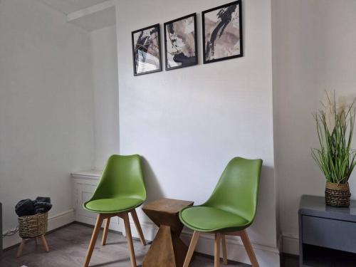 a room with two green chairs and a table at Welsh Retreat, BikeParkWales, Brecon Beacons, ZipWorld Tower in Troed-y-rhiw