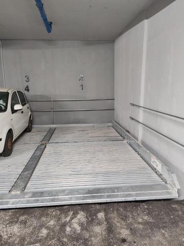 a parking garage with a car parked in it at Apartment Stevanovic Belgrade in Vračar (historical)