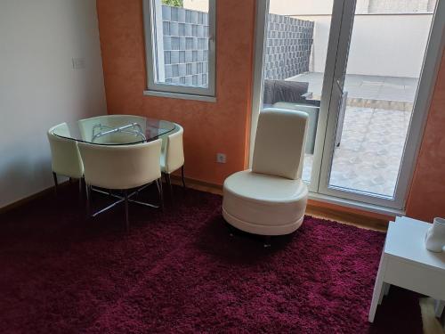 a dining room with a glass table and two chairs at Apartment Stevanovic Belgrade in Vračar (historical)