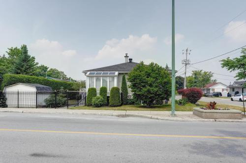 a house on the corner of a street at 4 Beds Entire House Wifi Parking in Laval-des-Rapides