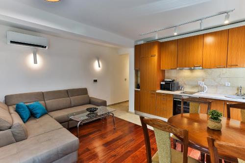 a living room with a couch and a table and a kitchen at Luxury Apartments Przno in Budva