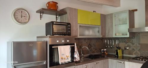 a kitchen with a refrigerator and a clock on the wall at Il Borghetto in Pesaro