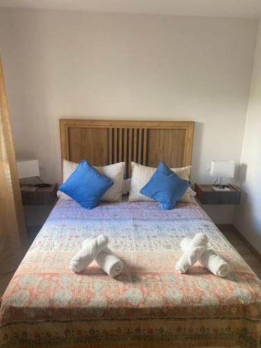 a bedroom with a bed with two shoes on it at Edulis 2 in Arenas de San Pedro