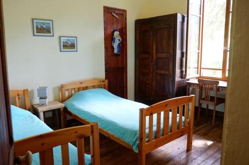 a bedroom with two bunk beds and a table at La Chaumière, Formule maison entière in Colmars