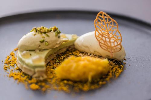 a piece of food on a plate with spices at Domaine de la Tortinière in Montbazon
