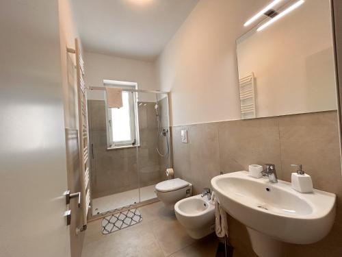 a bathroom with a sink and a toilet and a mirror at I Trulli e la Luna in Alberobello