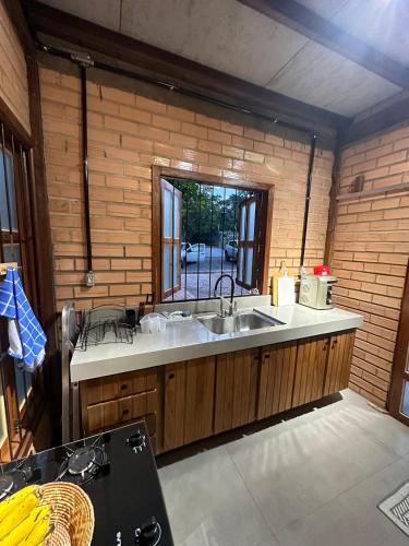 a kitchen with a sink and a window at Casa do Lago em Alter do Chão in Alter do Chao