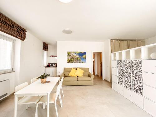 a living room with a table and a couch at I Trulli e la Luna in Alberobello