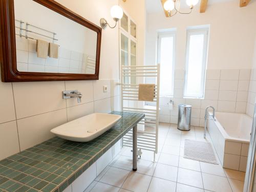 a bathroom with a sink and a tub at Ejas Haus am Meer in Lubmin