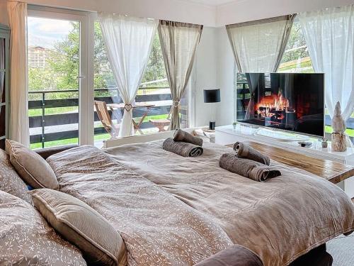 a large bed in a bedroom with a fireplace at Christiania Central Nendaz in Nendaz