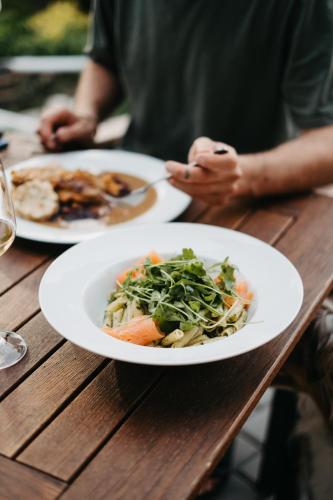 a person sitting at a table with two plates of food at Amenity Penzion Horni Vestonice in Horní Věstonice