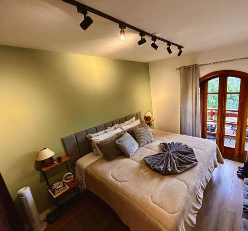 a bedroom with a large bed in a room at Duplex Luxo Quatre Saisons MBFlats Campos do Jordão 1 in Campos do Jordão