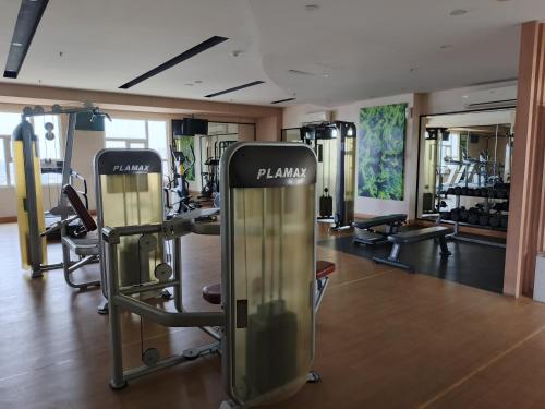 a gym with a bunch of treadmills and machines at 2BR Lucky Tower Residence Jakarta Old Town Top Floor Condo in Jakarta