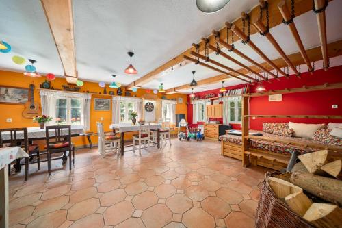 a living room with orange walls and a dining room at Chalupa U Horníků in Vítkovice
