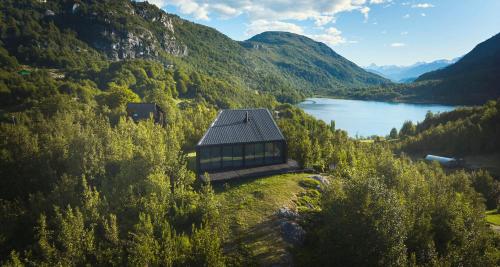 a building on the side of a hill next to a lake at MA PU LODGE Futaleufu in Futaleufú