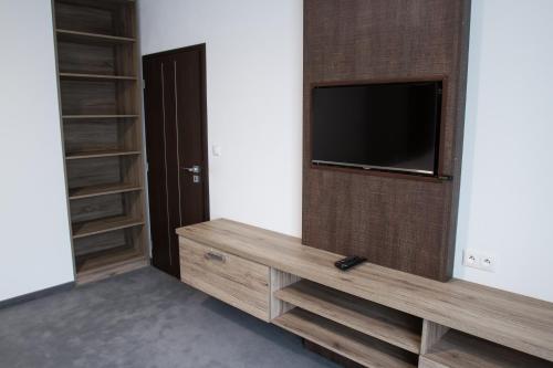 a living room with a flat screen tv on a wall at Guest House Frizzante in Turčianske Teplice