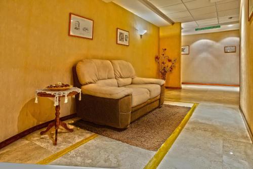 a living room with a chair and a table at Hotel Lory & Ristorante Ferraro in Celano
