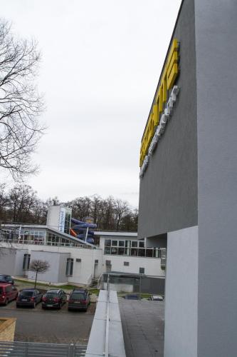a building with cars parked in a parking lot at Guest House Frizzante in Turčianske Teplice
