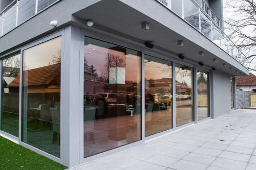 an office building with glass doors and windows at Guest House Frizzante in Turčianske Teplice