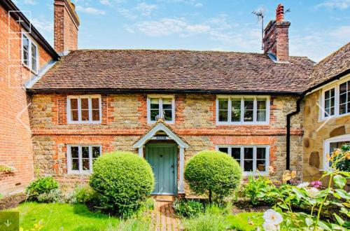 an old brick house with a green door at Super Host Large Luxury Cottage South Downs Park in Lodsworth