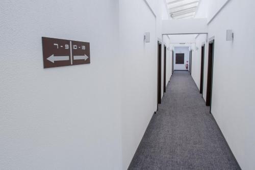 a hallway in an office building with a sign on the wall at Guest House Frizzante in Turčianske Teplice