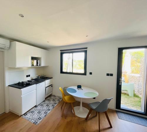 une cuisine avec une table et des chaises jaunes dans une pièce dans l'établissement La villa ACÉA, à Saint-Zacharie