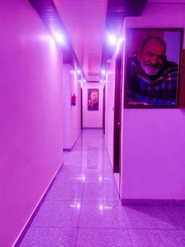 a hallway with purple lights in a room at Hotel STAY INN in Haldwāni