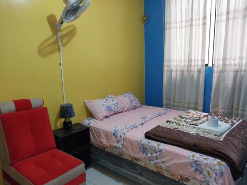 a bedroom with a bed and a lamp and a chair at D202 in Moyobamba