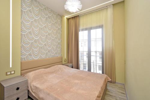 a bedroom with a bed and a large window at Very beauty new apartment for good guests in Arabkir