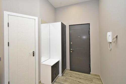 a bathroom with a white door and a phone at Very beauty new apartment for good guests in Arabkir