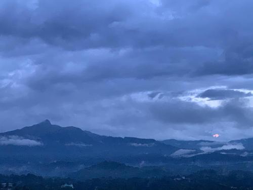 a cloudy sky with mountains in the background at Galkaduwa360 Villa in Kandy