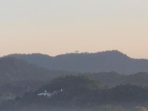 a house on a hill with mountains in the background at Galkaduwa360 Villa in Kandy