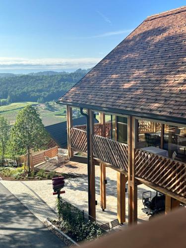 a large wooden house with a large roof at Fräulein Leni Hotel in Gamlitz