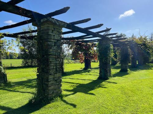 a stone archway in a field of grass at Bank House Longtown in Longtown