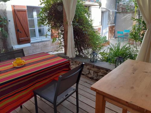 une table et une chaise sur une terrasse dans l'établissement Joli F2 tout confort avec jardin, à Vichy