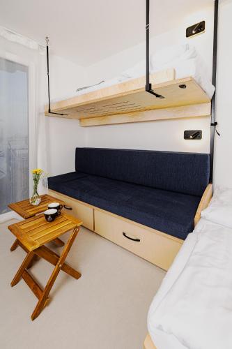 a small bedroom with a bed and a table at YACHTER CLUB Modrá Čajka in Dunacsún