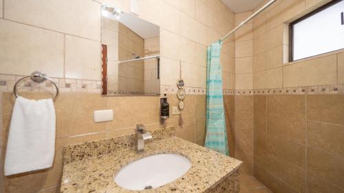 a bathroom with a sink and a shower at MonteMar Beach Condo At Playa hermosa in Sardinal