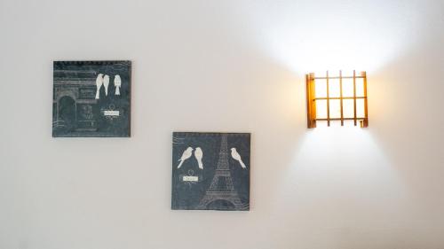 two pictures of the eiffel tower and a light on a wall at MonteMar Beach Condo At Playa hermosa in Sardinal