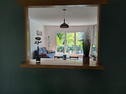 a living room with a couch and a window at Maison au calme 3 chambres avec terrasse et jardin in Ouzouer-sur-Loire