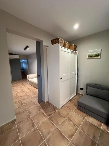 a living room with a couch and a cabinet at Calendula Hotel & Apartaments in Sant Feliu de Guixols