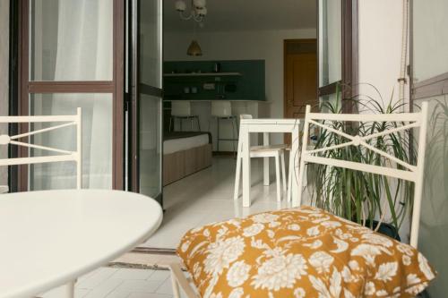 a room with a balcony with a table and chairs at FAVILLA - Lanciano Studios & Apartments in Lanciano
