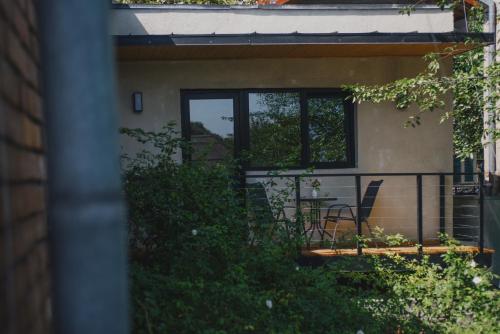 a house with a balcony with a table and chairs at Room&Garden in Mtskheta