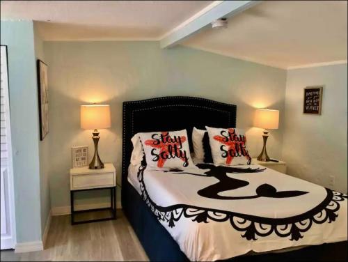 a bedroom with a bed with pillows and two lamps at Neptune's Grotto Old Florida Adventure Retreat in Spring Hill