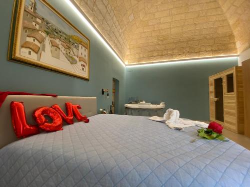 a bedroom with a large bed with red pillows at Suite san Giorgio in Gravina in Puglia